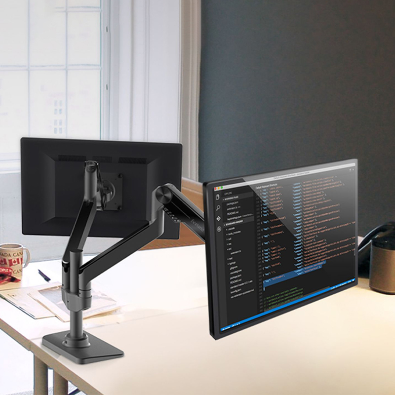 How does the floating design of a double-arm stand for computer monitors free up workspace?